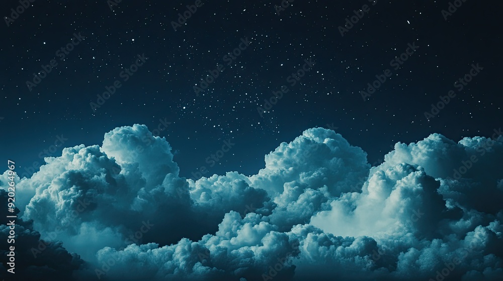 A dreamy image of a dark blue night sky, with large, fluffy clouds and a scattering of stars creating a magical atmosphere.