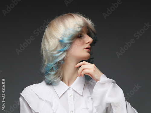 Portrait woman with bright blue colored hair. Hair coloring, beautiful lips and makeup. Sexy girl with short hair.