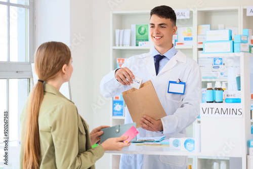 Male pharmacist with prescr...