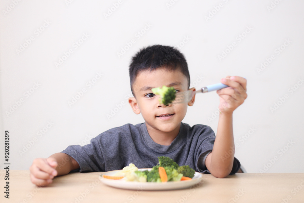 Nutrition healthy eating habits for kids concept. Children do not like to eat vegetables. Little cute boy refuses to eat healthy vegetables. Nutrition healthy eating habits for kids concept. Children do not like to eat vegetables. Little cute boy refuses to eat healthy vegetables.
