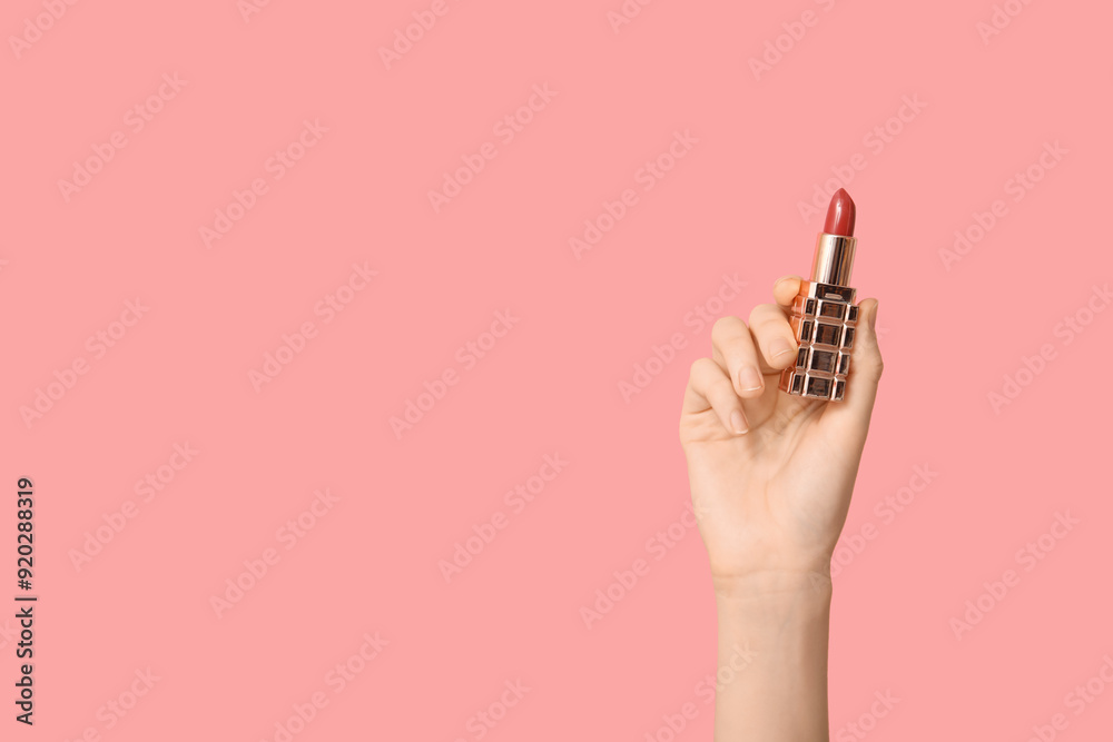Female hand with lipstick on pink background Female hand with lipstick on pink background