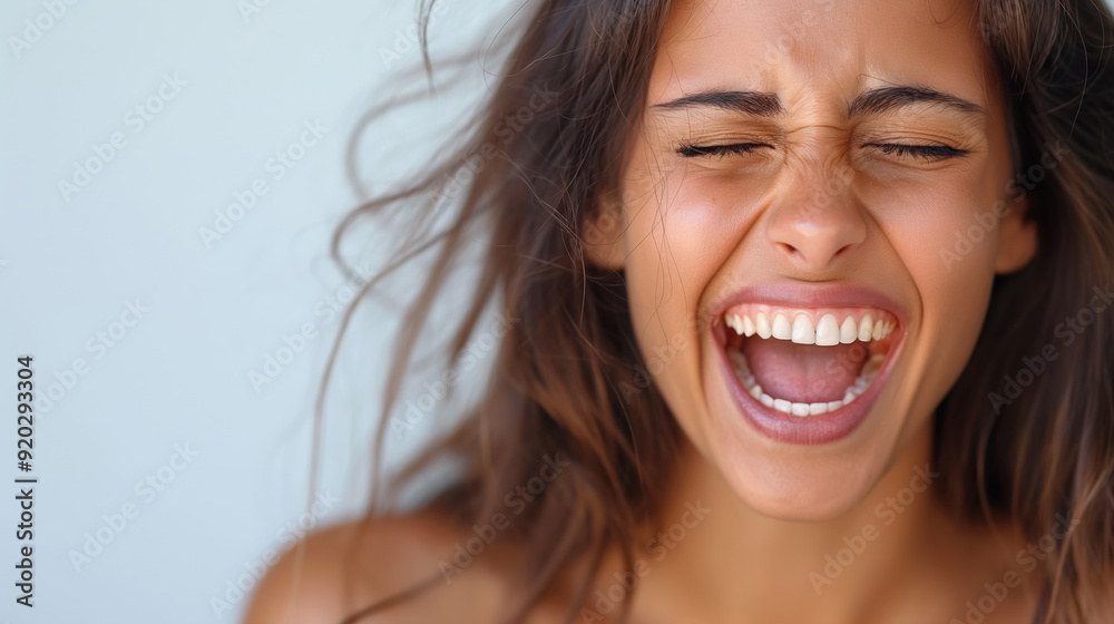Woman laughing with mouth wide open, capturing a moment of pure joy and emotion, with windswept hair and radiant expression. Woman laughing with mouth wide open, capturing a moment of pure joy and emotion, with windswept hair and radiant expression.