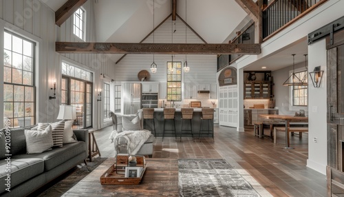 Modern living room and kitchen in a cozy home with large windows and wooden beams