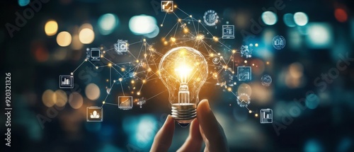 Hand holding a light bulb with glowing lines connecting it to various icons, representing new ideas, innovation, and technology.