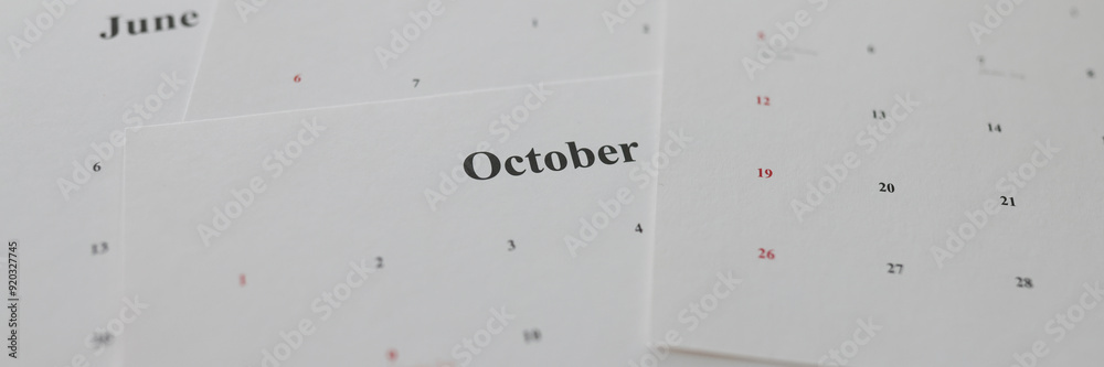 Calendar papers with marked dates lying on table Calendar papers with marked dates lying on table