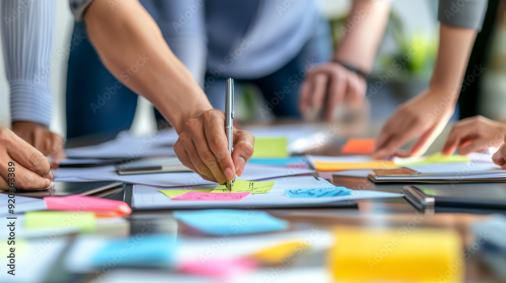 Business partners brainstorming ideas on sticky notes Business partners brainstorming ideas on sticky notes