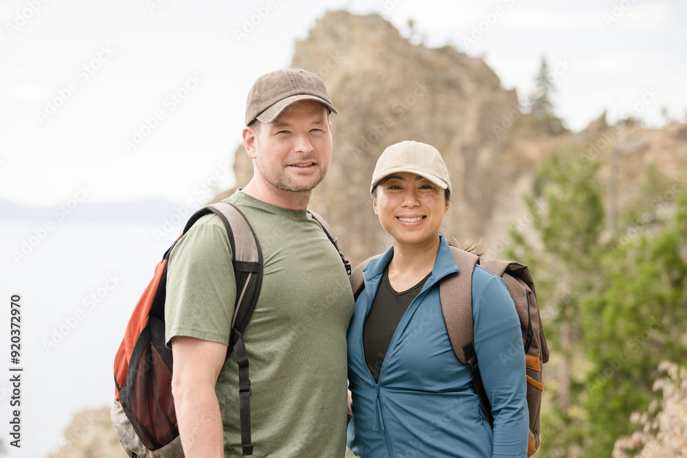Hiker Couple smiling at the camera with mountain behind them Hiker Couple smiling at the camera with mountain behind them