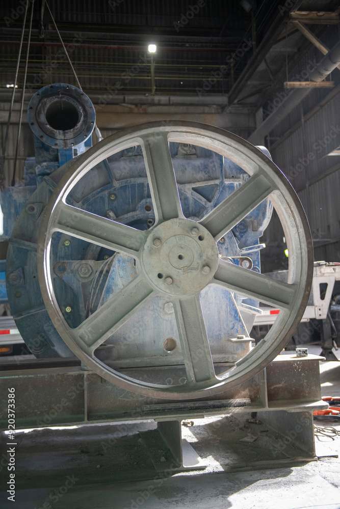 Large industrial size pully and motor in a mine processing plant Large industrial size pully and motor in a mine processing plant