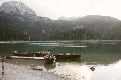 View of the Black Lake or Crno jezero , northern Montenegro. Tourist boats near wooden pier on Black lake in Durmitor national park near Zabljak, Europe photo