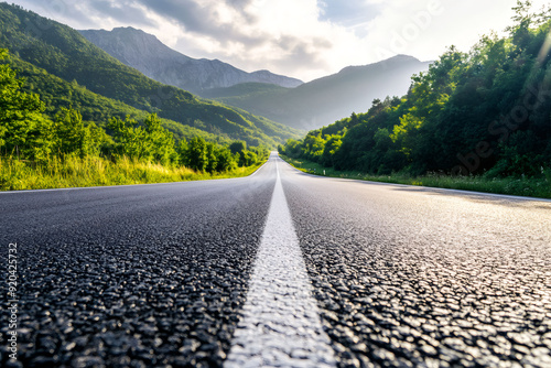 Asphalt road through mountains background.