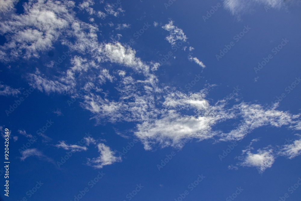 A bright sky with fluffy clouds as a good weather background image A bright sky with fluffy clouds as a good weather background image