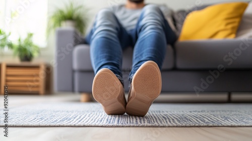 240805 77. A man experiencing discomfort at toe in living room. Metatarsal ligament irritation caused by chronic pressure and prolonged use of constrictive footwear. Medical illustration on white photo