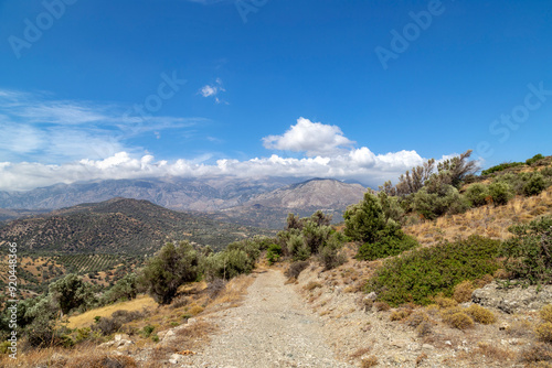 a hiking path in the region of Rethimou-Agias Galinis Ag. Vasilios, in southern Crete, Greece. The majestic peaks of the Ida Mountains can be seen in the background photo