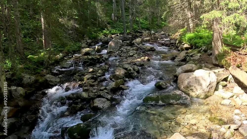 A beautiful mountain waterfall with a river flowing over the rocks. A beautiful mountain waterfall with a river flowing over the rocks.