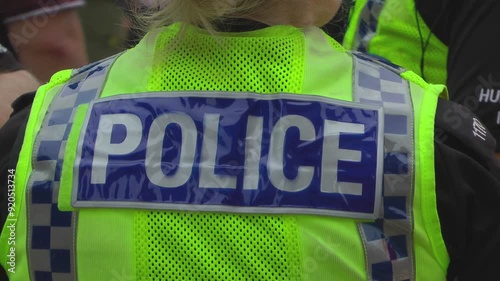 UK Police. CU high visibility uniform on police officer.