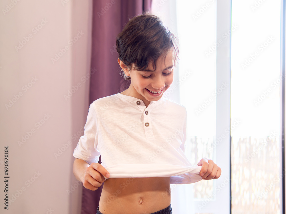 Young boy dressing up in bedroom Young boy dressing up in bedroom