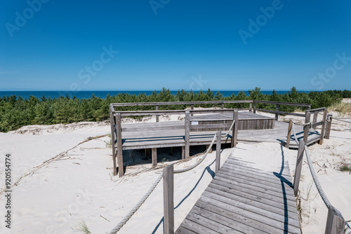 Obraz na płótnie Viewpoint of the Dunes in Lubiatowo. A wooden viewing platform covered with gray boards. The Baltic Sea in the distance w salonie