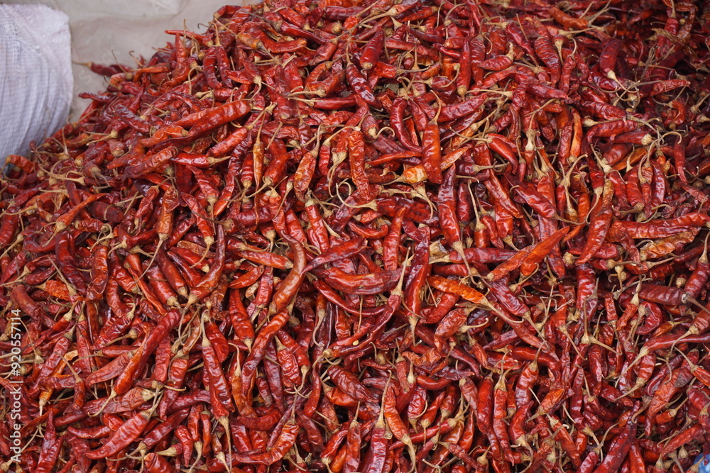 Fototapeta premium A heap of dry red chili pepper is displayed in a spice market, Dried spicy red chilies are on sale, Showcase of spicy red chili in a spice shop in Asia for the spice trade