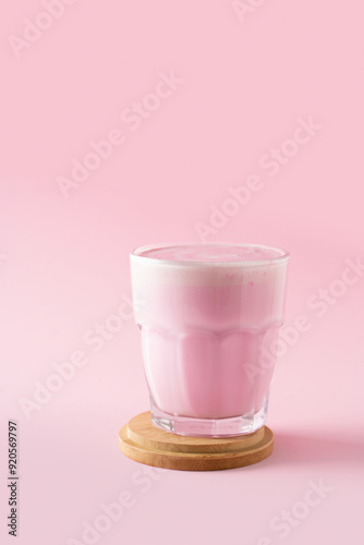 Pink matcha latte with powder on white background