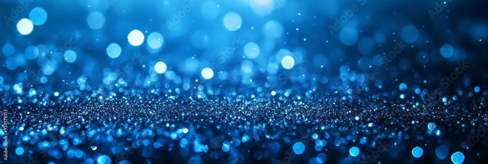 A defocused background of abstract glitter lights. Gold, blue, and black. A defocused background of abstract glitter lights. Gold, blue, and black.