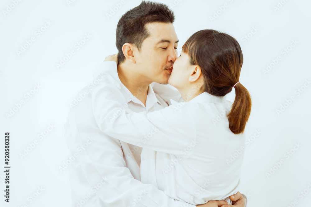 A middle-aged Asian couple, with the woman being pregnant, shares a loving embrace, smiling with happiness and anticipation for their soon-to-arrive baby, symbolizing family togetherness and joy. A middle-aged Asian couple, with the woman being pregnant, shares a loving embrace, smiling with happiness and anticipation for their soon-to-arrive baby, symbolizing family togetherness and joy.