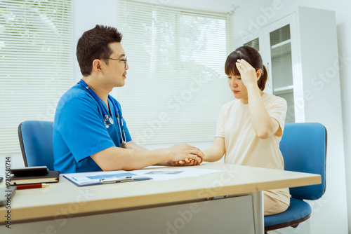 A male Asian pediatrician in a white lab coat conducts a prenatal checkup for a middle-aged pregnant woman, focusing on maternal and fetal health, offering expert care and guidance. photo