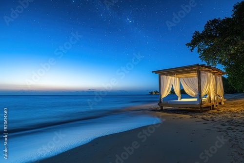 Luxury Beach Cabana at Night with Starry Sky and Tranquil Ocean Waves
