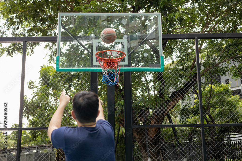 Fototapeta premium Man Stretching on Basketball Court Outdoors