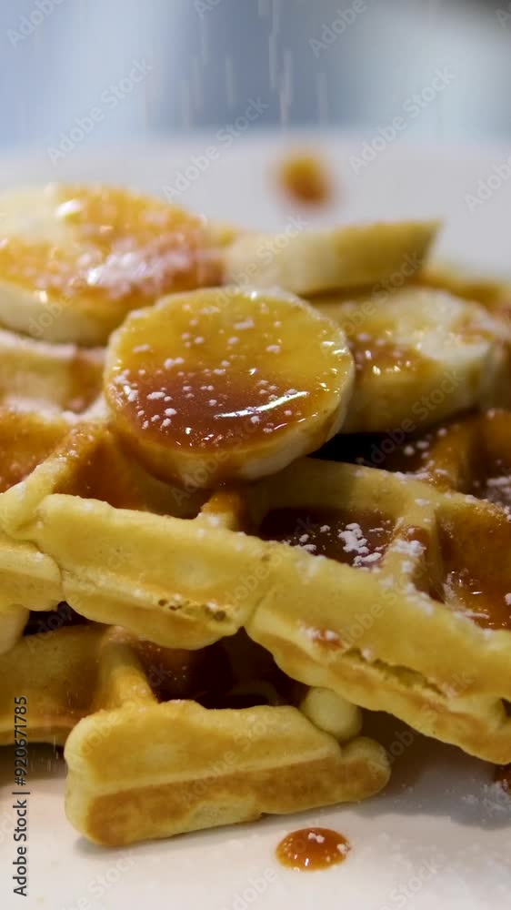 Delicious Belgian waffles with banana, whipped cream and caramel sauce isolated on white Delicious Belgian waffles with banana, whipped cream and caramel sauce isolated on white