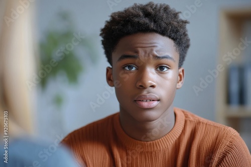 Close-up of distressed black teenage boy on counselling with psychotherapist, Generative AI