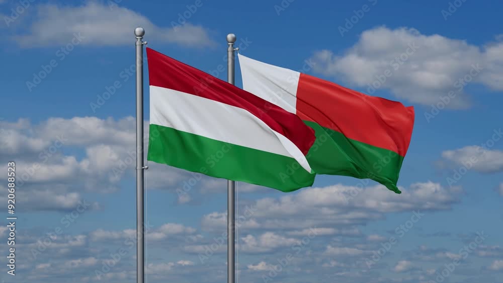 Madagascar and Hungary flags flying together, video concept of the relationship, two country relations concept Madagascar and Hungary flags flying together, video concept of the relationship, two country relations concept