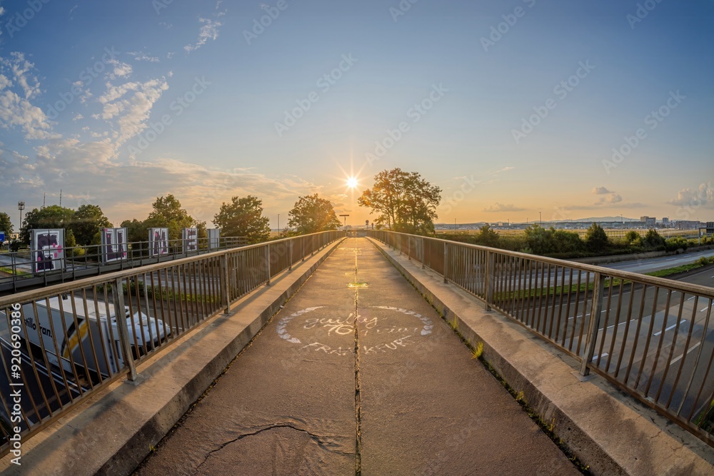 Fototapeta premium Picture over a highway bridge to the setting sun