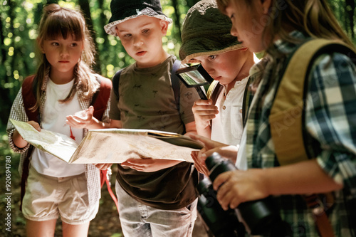 Wallpaper Mural Looking at the map. Kids in forest at summer daytime together Torontodigital.ca