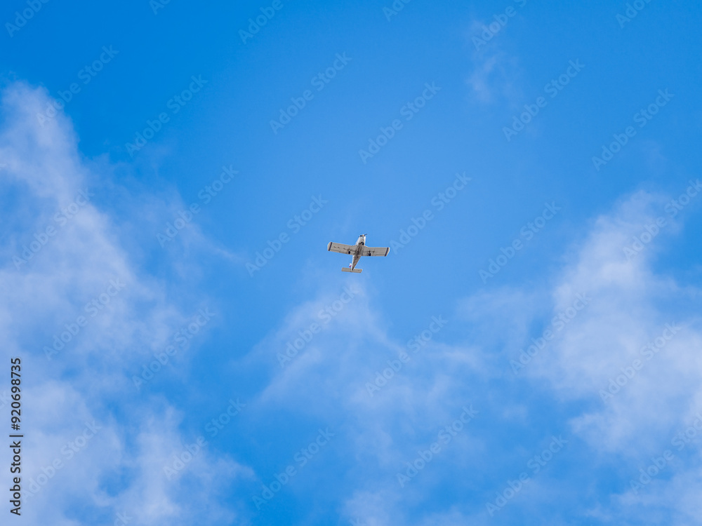 Small ultralight airplane with overhead wing and single propeller flying in sunset sky. Small ultralight airplane with overhead wing and single propeller flying in sunset sky.