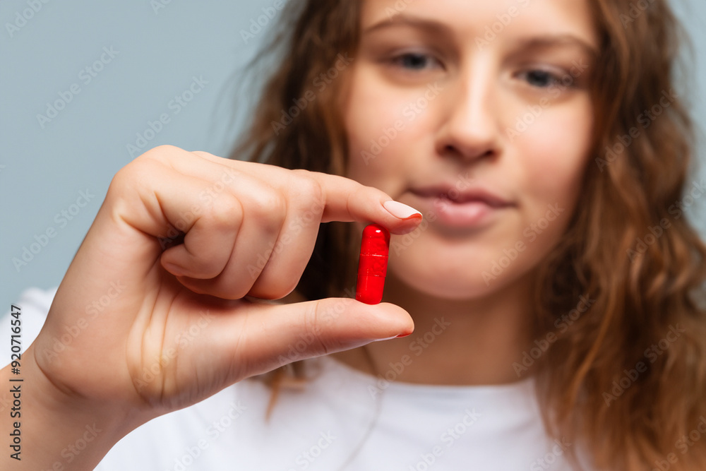 Tablet is treatment for cancer that can be used at home to prevent it from spreading. health healthy medicine concept. a girl holding a pill in red. a girl holding a tablet of prevention and. Tablet is treatment for cancer that can be used at home to prevent it from spreading. health healthy medicine concept. a girl holding a pill in red. a girl holding a tablet of prevention and.