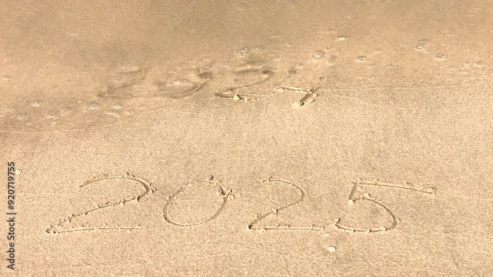 The concept of the New Year. The text of 2025, handwritten on a sandy surface. The figures of 2024 were washed away by the sea wave. We welcome the year 2025. Happy New Year. Seashore, waves, sand. The concept of the New Year. The text of 2025, handwritten on a sandy surface. The figures of 2024 were washed away by the sea wave. We welcome the year 2025. Happy New Year. Seashore, waves, sand.