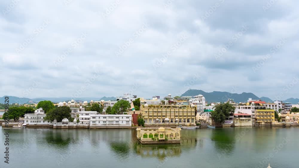 4K Ken Burn timelapse of clouds moving over beautiful Udaipur city and lake Pichola at Rajasthan, India. City buildings and palace with vie of Lake Pichola in Udaipur. Travel and Holidays concept. 4K Ken Burn timelapse of clouds moving over beautiful Udaipur city and lake Pichola at Rajasthan, India. City buildings and palace with vie of Lake Pichola in Udaipur. Travel and Holidays concept.