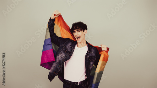 Funny guy posing with a gay flag. photo