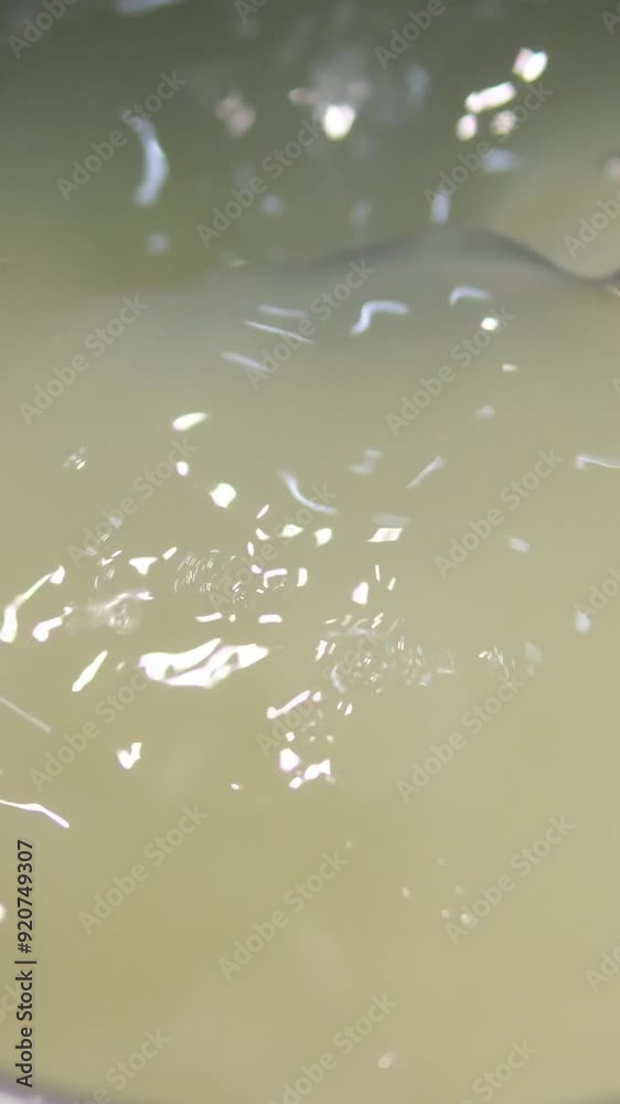 Close-up of woman hands washing white rice in colander in a bowl