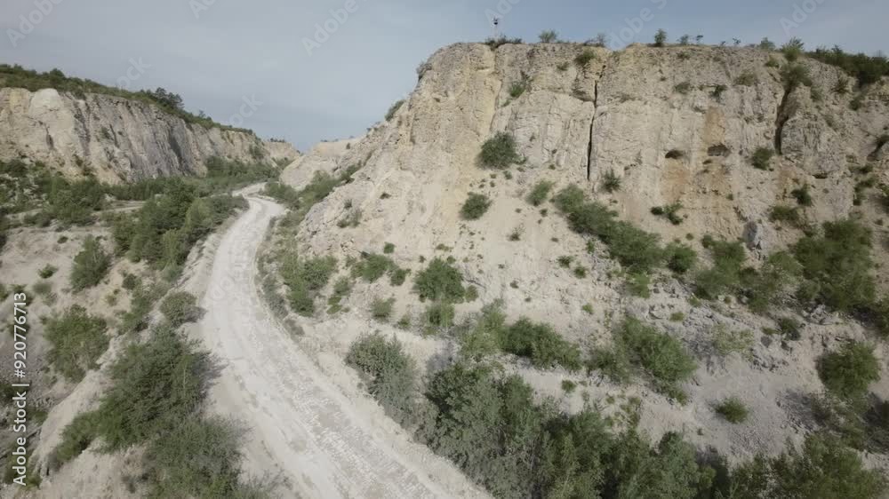 This breathtaking aerial video showcases the stunning landscape of a limestone quarry. The video opens with a sweeping panoramic shot of the quarry, revealing its vast expanse and intricate details This breathtaking aerial video showcases the stunning landscape of a limestone quarry. The video opens with a sweeping panoramic shot of the quarry, revealing its vast expanse and intricate details