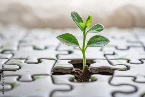 A vibrant green sprout grows through a floor made of puzzle pieces, capturing the beautiful interplay between nature and human creativity under gentle lighting conditions. photo