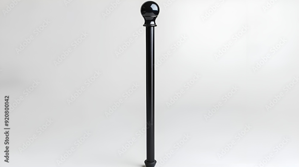 A black pole stands prominently against a clean, white background. A black pole stands prominently against a clean, white background.