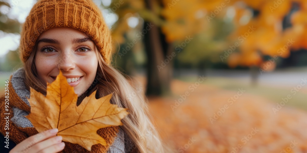 Portrait of a young Woman Holding Autumn Leaf in Park Portrait of a young Woman Holding Autumn Leaf in Park