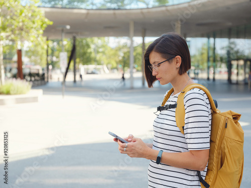 Asian woman over background of modern urban architecture in Vienna.