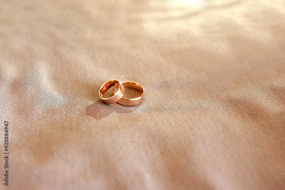 Two gold wedding rings on a gray cloth. Two gold wedding rings on a gray cloth.