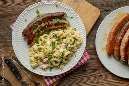 Traditional german Bratwurst with homemade pasta salad. Delicious rustic food