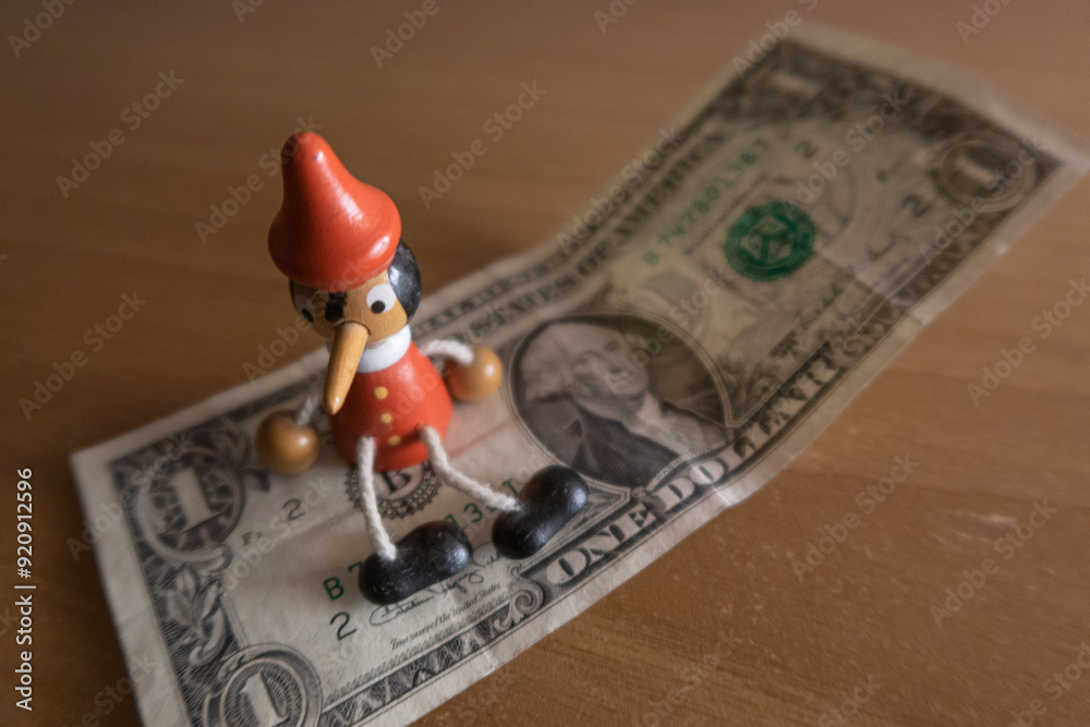 US dollar detail pinocchio sitting on banknote
