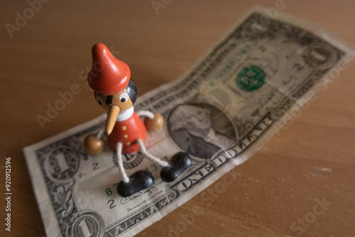 US dollar detail pinocchio sitting on banknote