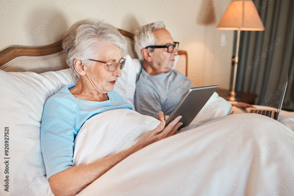 Senior, couple and relax with technology in bedroom for reading online news, ebook and browsing internet. Elderly people, streaming and home at night for subscription for application or entertainment Senior, couple and relax with technology in bedroom for reading online news, ebook and browsing internet. Elderly people, streaming and home at night for subscription for application or entertainment
