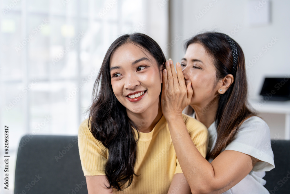 Two women are sitting on a couch Two women are sitting on a couch